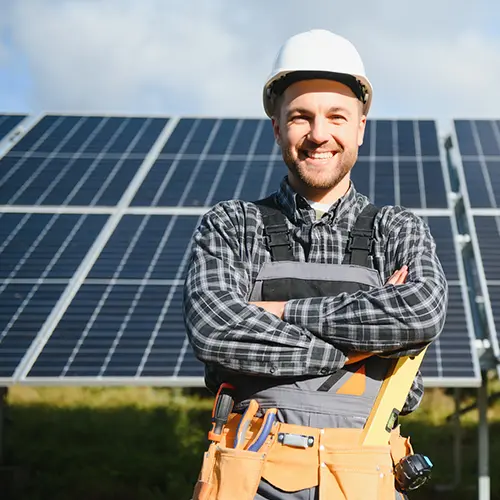 industry-solar a smiling technician standing in front of solar panels